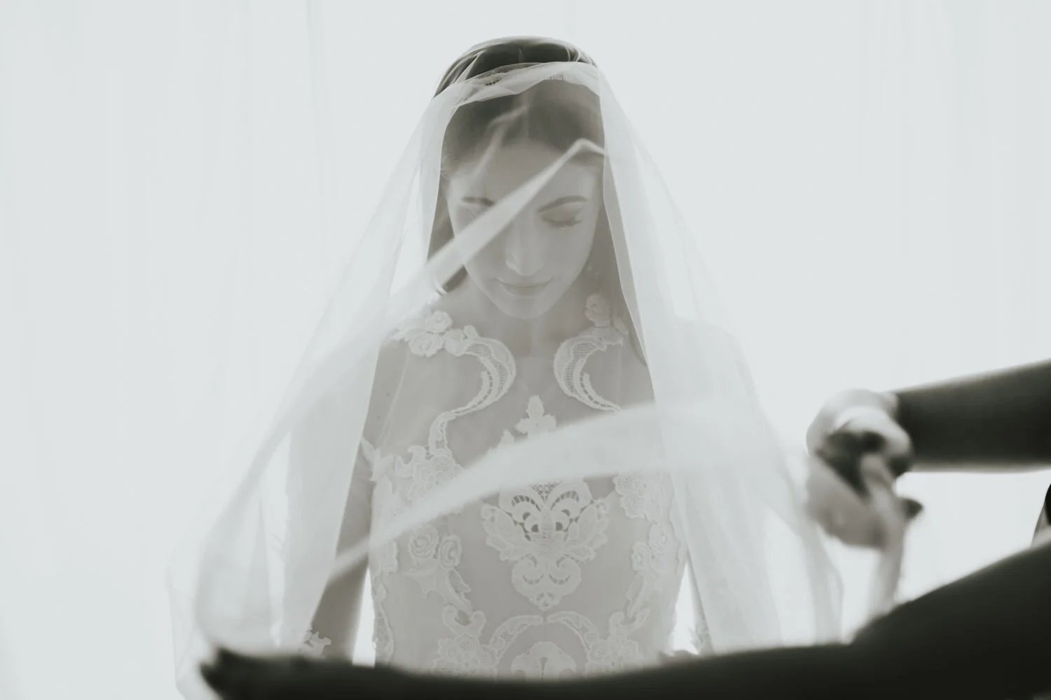 Bride seen softly through layers of a veil