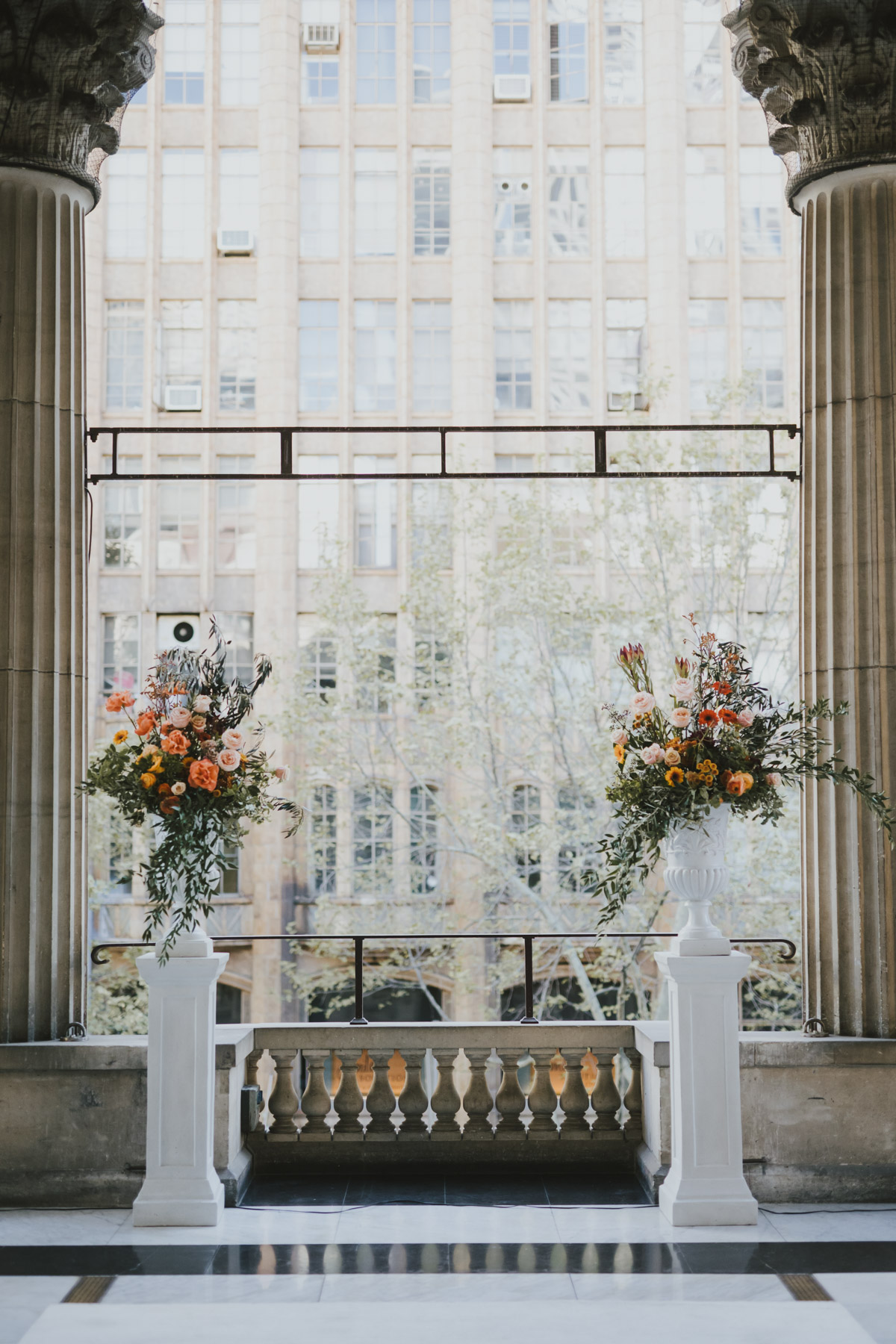 Symmetrical stone columns and floral plinths