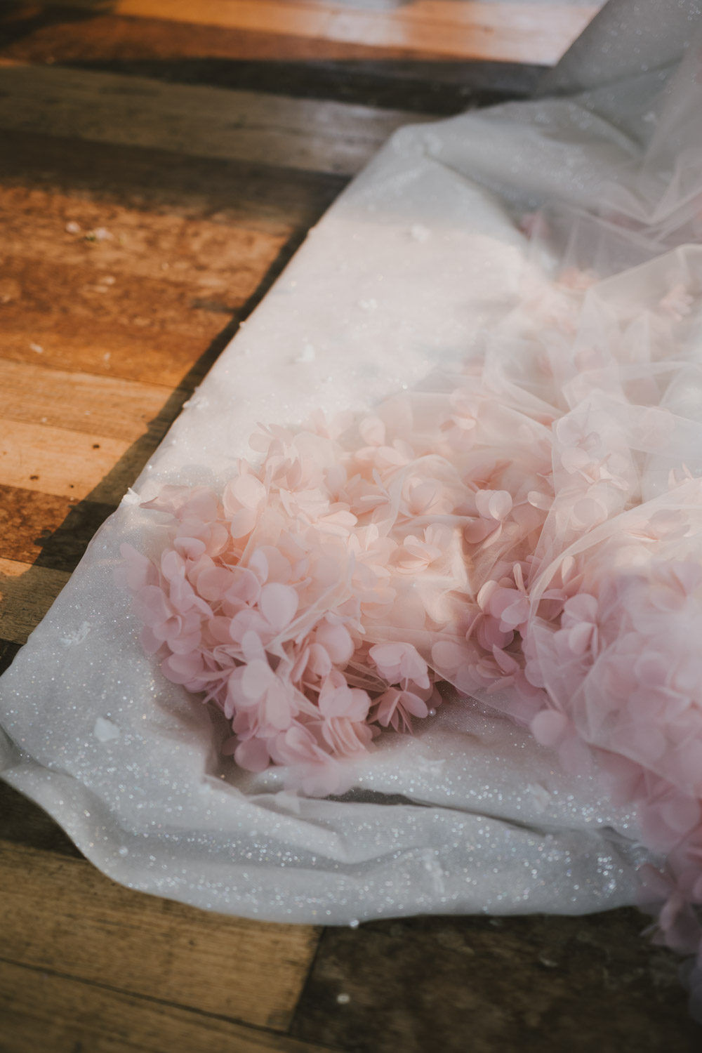Pink floral tulle and glittering fabric on timber
