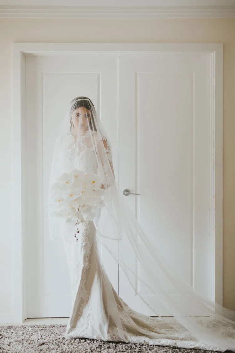 Bride facing the camera beneath a veil